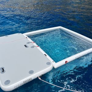 Anti Jellyfish Pool and Inflatable platform. White products in blue sea. Sunny day.