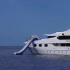 Big Yacht Slide in a boat. White boat, white slide, blue sea.