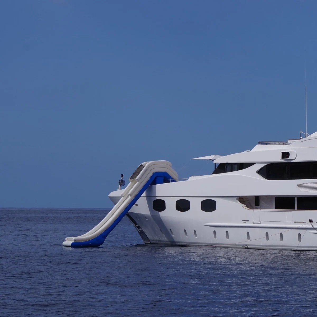 Big Yacht Slide in a boat. White boat, white slide, blue sea.